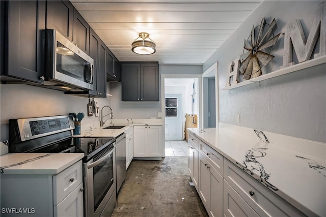 kitchen featuring white cabinetry, sink, and appliances with stainless steel finishes