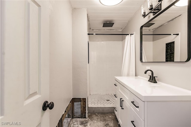 bathroom with curtained shower, vanity, and concrete floors