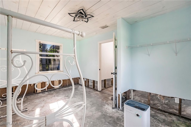 interior space with wooden ceiling and concrete flooring