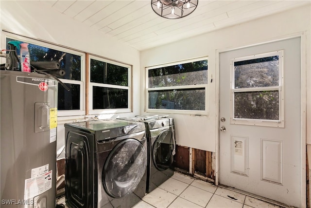 clothes washing area with washer and clothes dryer, electric water heater, and light tile patterned floors