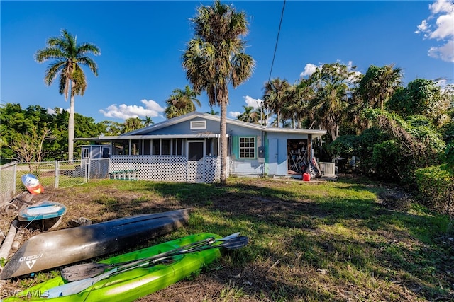 rear view of property featuring a sunroom