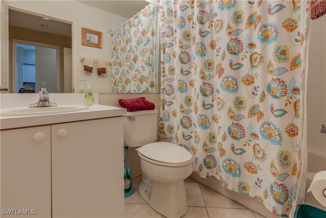 bathroom with toilet, vanity, tile patterned floors, and walk in shower