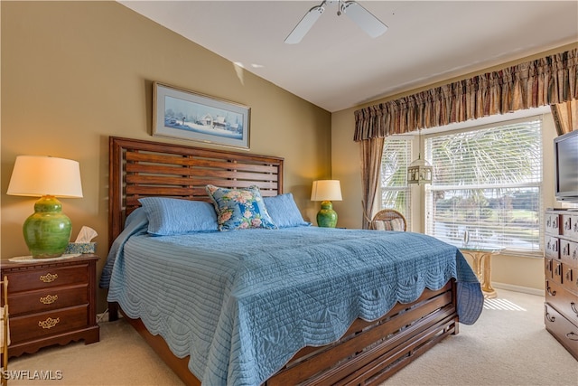 bedroom featuring light carpet, vaulted ceiling, and ceiling fan