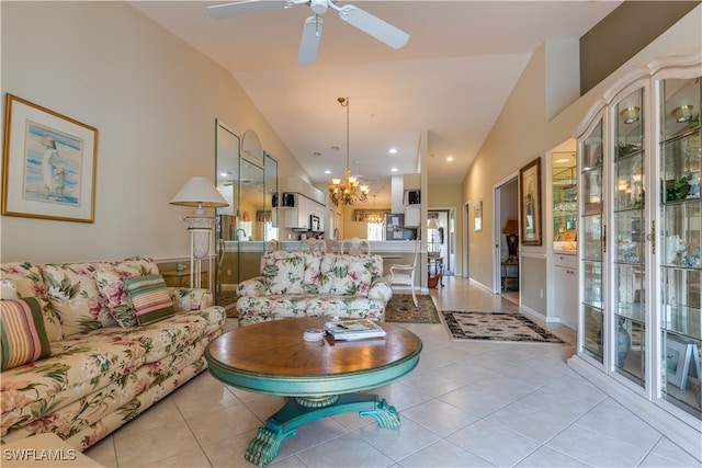 living room featuring vaulted ceiling, ceiling fan with notable chandelier, and light tile patterned floors