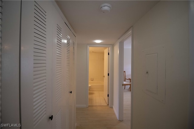 corridor with light hardwood / wood-style flooring