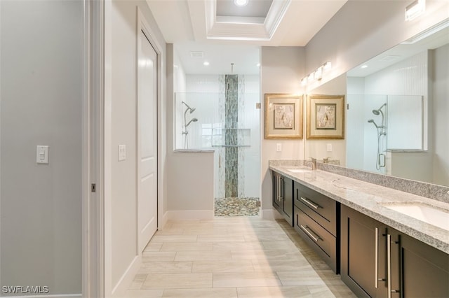 bathroom with vanity, a raised ceiling, and walk in shower