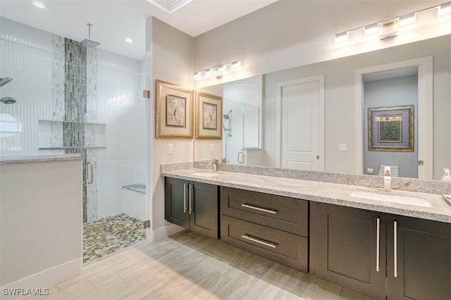 bathroom with vanity and a shower with shower door