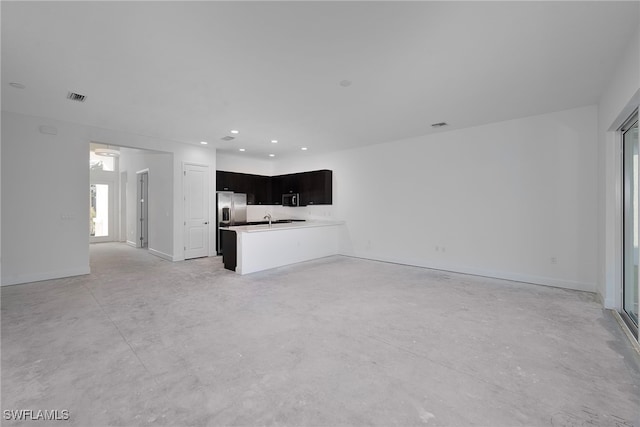 unfurnished living room with sink