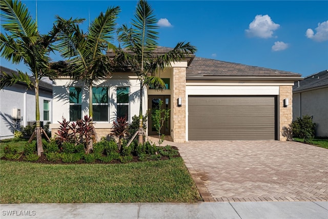 view of front of house with a garage and a front lawn