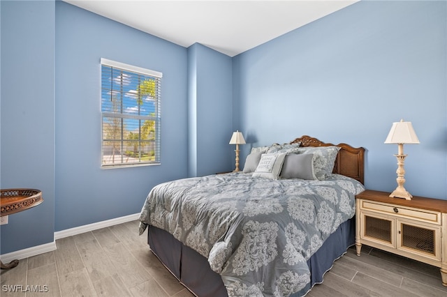 bedroom with wood-type flooring