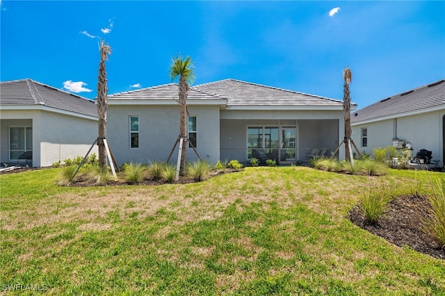 rear view of house with a yard