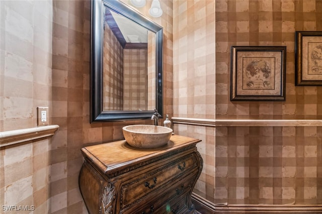 bathroom featuring vanity and tile walls