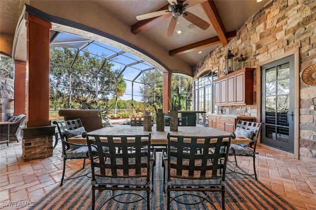 view of patio / terrace with ceiling fan, area for grilling, and glass enclosure