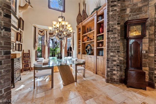 dining space with a high ceiling and an inviting chandelier