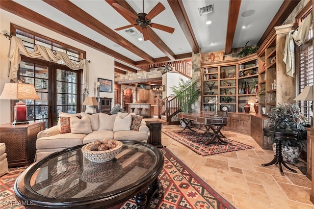 interior space with ceiling fan and beamed ceiling