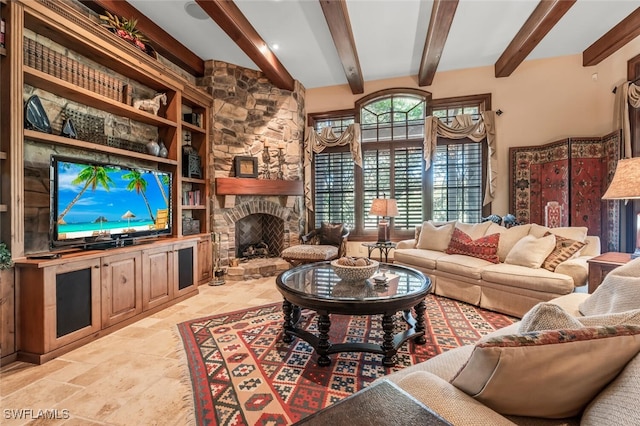 living room featuring beam ceiling and a fireplace