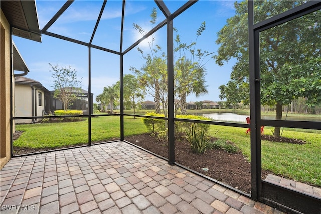 unfurnished sunroom with a water view