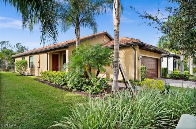 view of side of property with a lawn and a garage