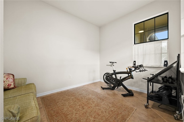 exercise area featuring light tile patterned flooring