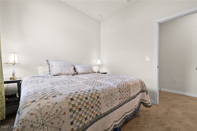 tiled bedroom featuring lofted ceiling