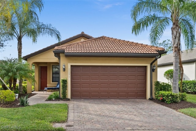 mediterranean / spanish home with a garage