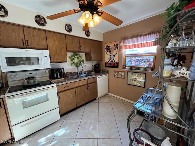 kitchen featuring ceiling fan, light tile patterned flooring, white appliances, and sink