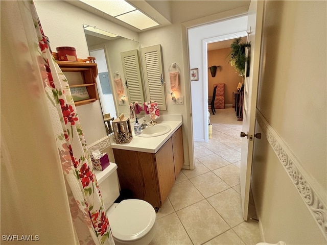 bathroom featuring tile patterned floors, vanity, and toilet