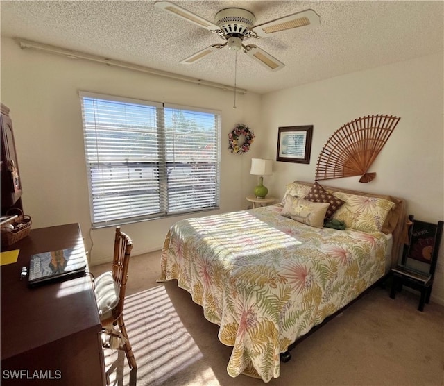 bedroom with dark colored carpet, a textured ceiling, and ceiling fan