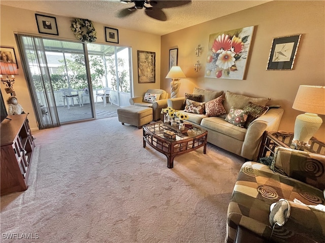 carpeted living room with a textured ceiling and ceiling fan