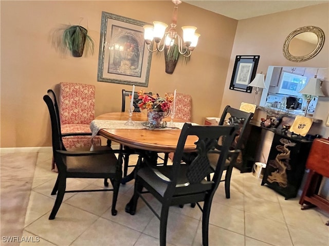 tiled dining room with a notable chandelier