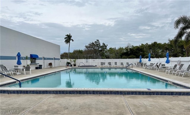 view of swimming pool with a patio