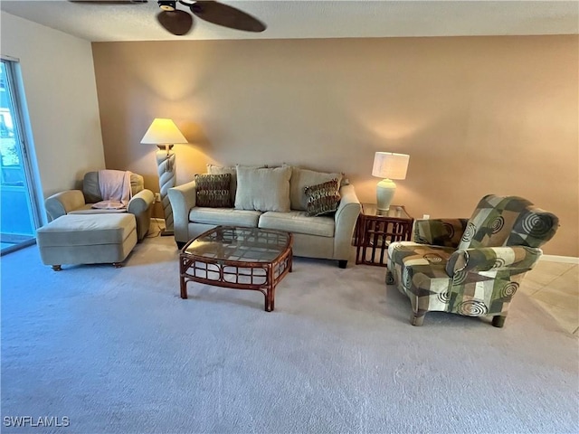 carpeted living room with ceiling fan