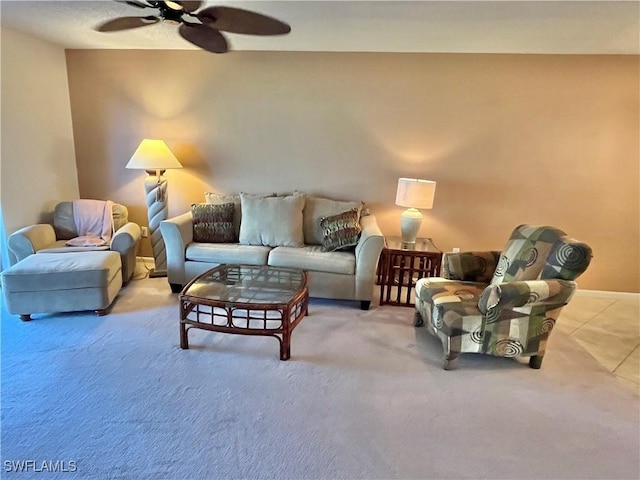 carpeted living room with ceiling fan