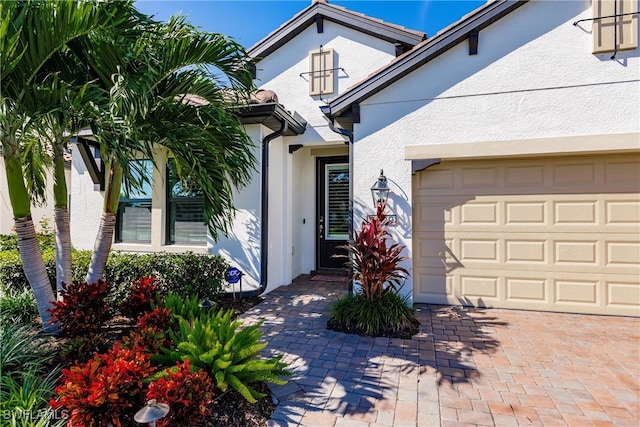 view of exterior entry featuring a garage