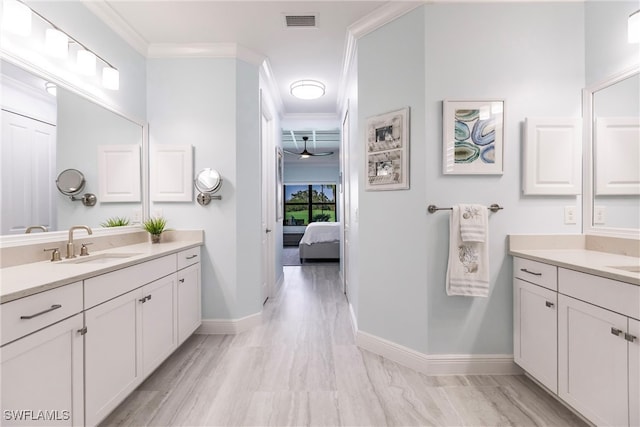 bathroom with hardwood / wood-style flooring, vanity, and ornamental molding