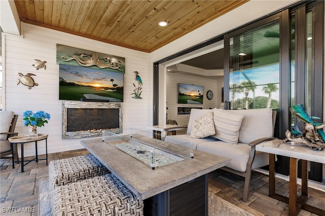 living room with wooden ceiling and wood walls