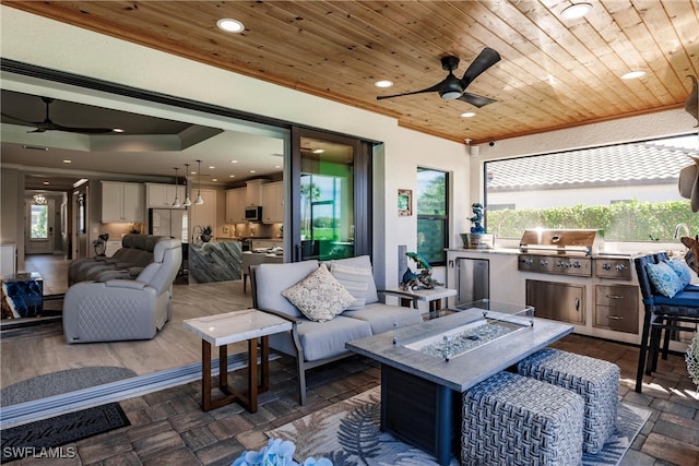 view of patio / terrace featuring an outdoor living space with a fire pit, area for grilling, ceiling fan, and a grill