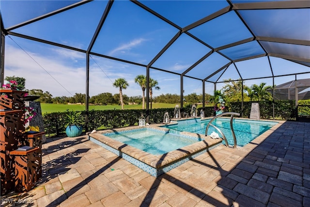 view of swimming pool with a lanai, an in ground hot tub, and a patio