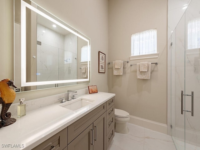 bathroom featuring vanity, a shower with shower door, and toilet