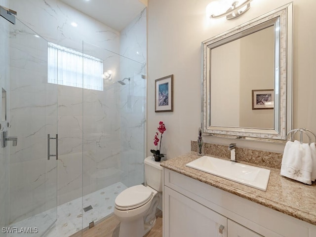 bathroom featuring vanity, hardwood / wood-style flooring, toilet, and walk in shower