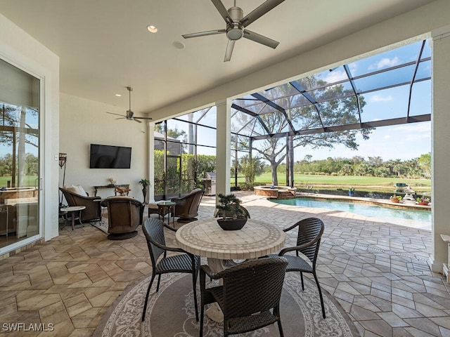 view of patio with ceiling fan, a lanai, and a pool with hot tub