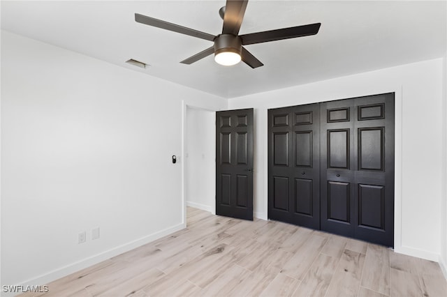 unfurnished bedroom with a closet, ceiling fan, and light hardwood / wood-style flooring