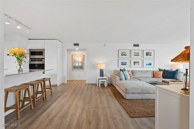 living room with light hardwood / wood-style floors