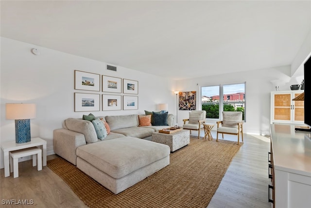 living room with light hardwood / wood-style flooring