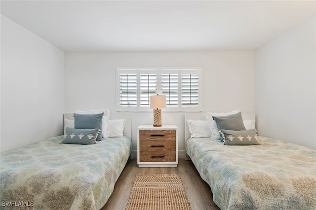 bedroom with dark hardwood / wood-style flooring