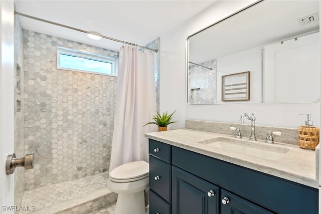 bathroom featuring vanity, curtained shower, and toilet