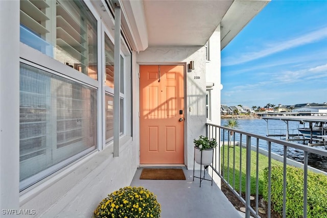 1100 8th Ave S Unit 230K, Naples, FL 34102 - doorway to property featuring a water view, a balcony, and stucco siding