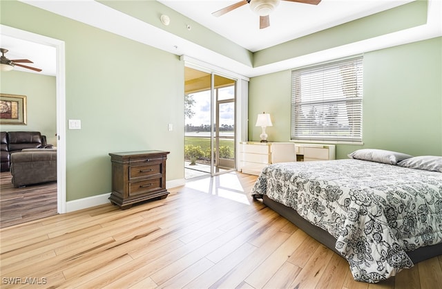 bedroom featuring light wood-type flooring, access to exterior, baseboards, and a ceiling fan