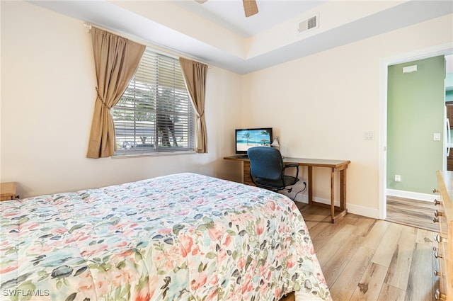 bedroom with light wood-type flooring, visible vents, ceiling fan, and baseboards