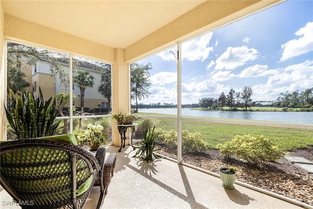 sunroom featuring a water view and a wealth of natural light